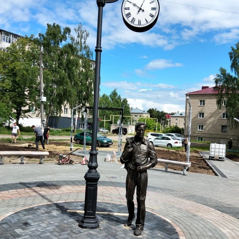 Городская скульптура из бронзы в виде фигуры мужчины с букетом цветов